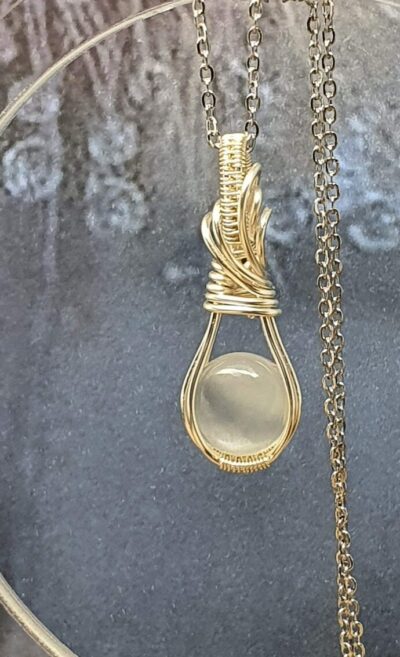 Pendentif pierre de lune adulaire ronde sertie à la main par la méthode du wire wrapping